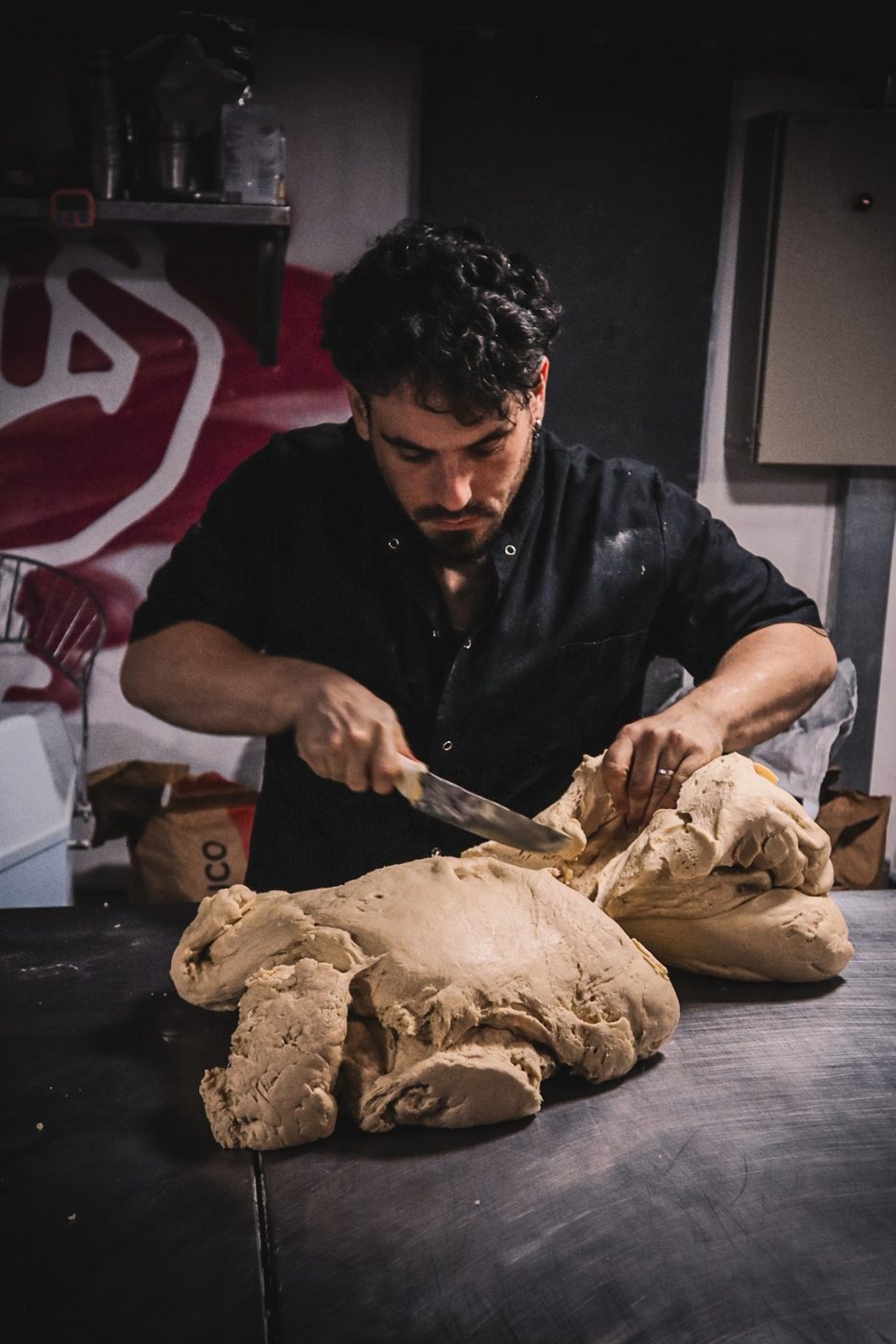 Nicolás cortando un bollo grande de masa